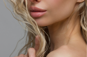 Close-up of woman's Lips with Fashion pink Make-up and Manicure on Nails